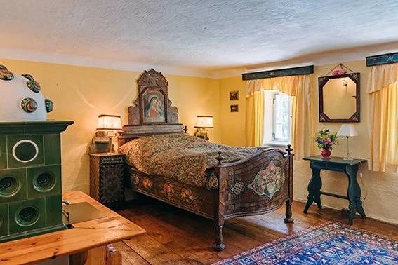 Courtyard Ensuite Room with a hand-carved antique bed and folk-art icons