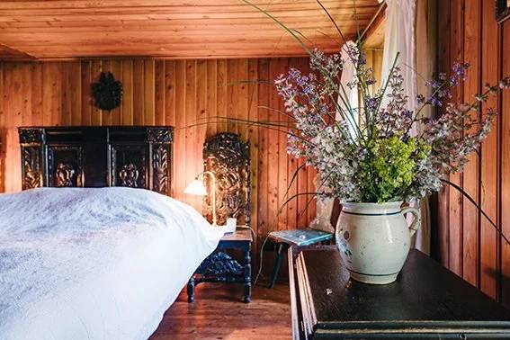 Double Room With Balcony featuring wrought-iron beds and a hand-painted tile stove