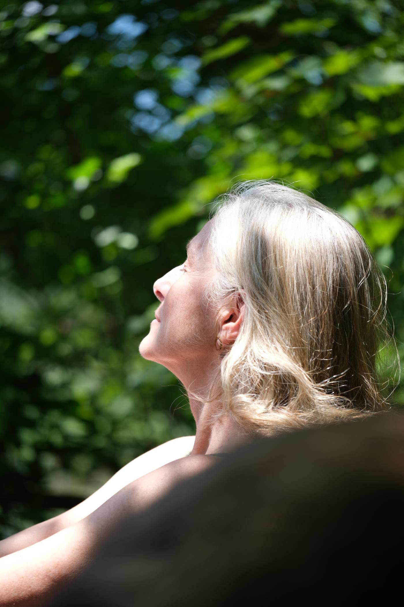 Woman with her face turned toward the sun